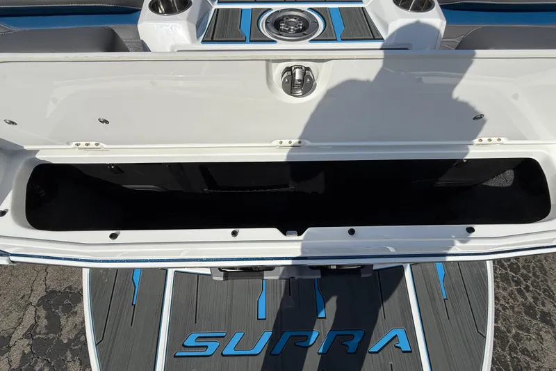 Slide: The Image of 2026 Supra SA 450 boat storage compartment with open lid, showcasing interior space. - 56