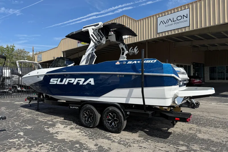 Slide: The Image of 2026 Supra SA 450 boat in blue and white, parked at Avalon Luxury Pontoons dealership. - 6