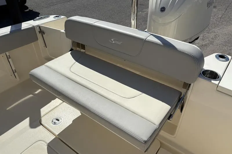 Slide: The Image of 2026 Scout 240 XSF boat with cushioned seating and cup holders. - 10