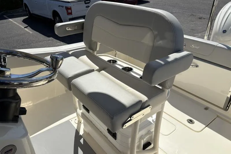 Slide: The Image of 2026 Scout 240 XSF boat interior with cushioned seating and steering wheel. - 17