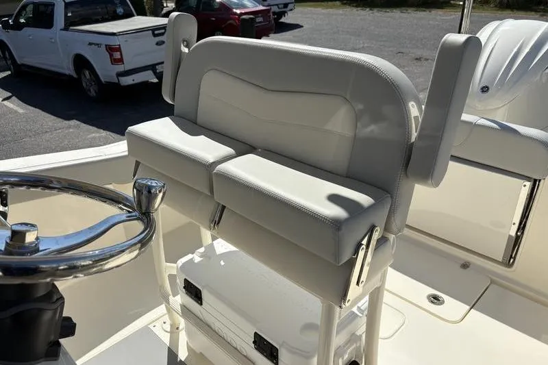Slide: The Image of 2026 Scout 240 XSF boat interior with cushioned seating and steering wheel. - 18