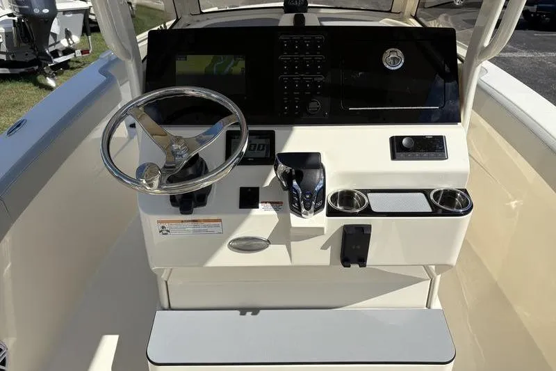 Slide: The Image of 2026 Scout 240 XSF boat dashboard with steering wheel and control panel. - 19