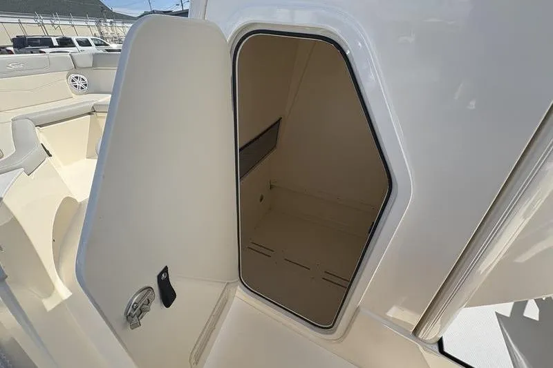Slide: The Image of Open storage compartment on 2026 Scout 240 XSF boat, showcasing interior space. - 26