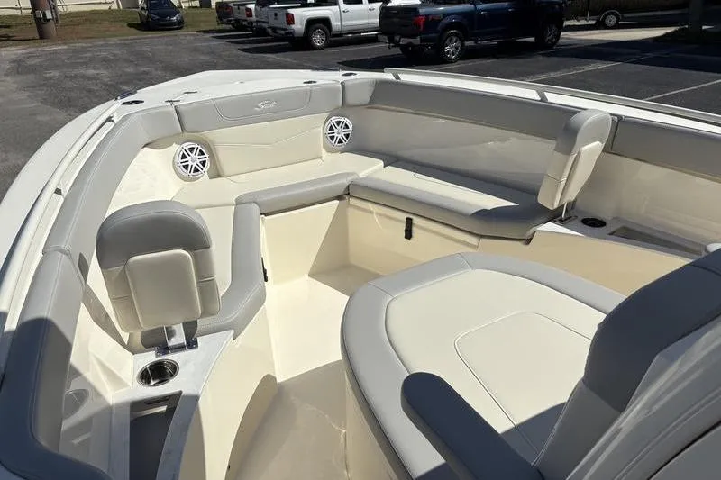 Slide: The Image of 2026 Scout 240 XSF boat interior with cushioned seating and cup holders. - 27