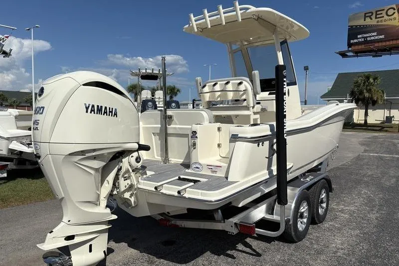 Slide: The Image of 2026 Scout 240 XSF boat with Yamaha engine on trailer, parked outdoors. - 3