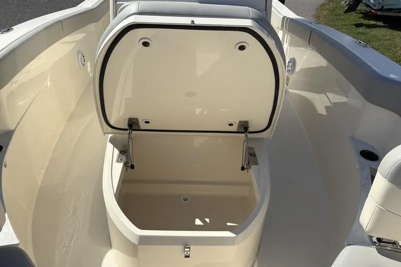 Slide: The Image of 2026 Scout 240 XSF boat with open storage compartment on deck. - 30