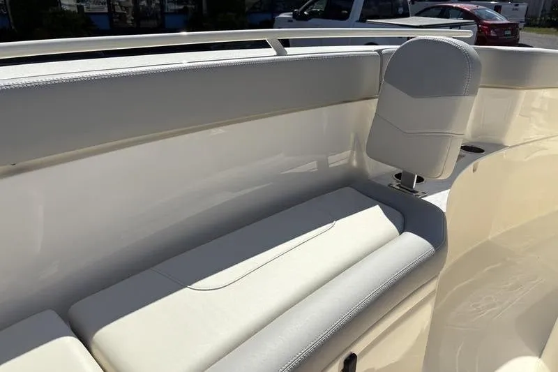 Slide: The Image of 2026 Scout 240 XSF boat interior with white cushioned seating and sleek design. - 31