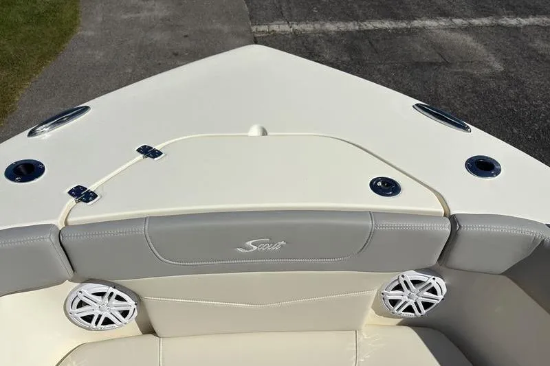 Slide: The Image of 2026 Scout 240 XSF boat interior with cushioned seating and speaker system. - 34
