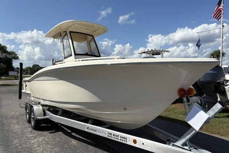 Slide: The Image of 2026 Scout 240 XSF boat on trailer under blue sky. - 5
