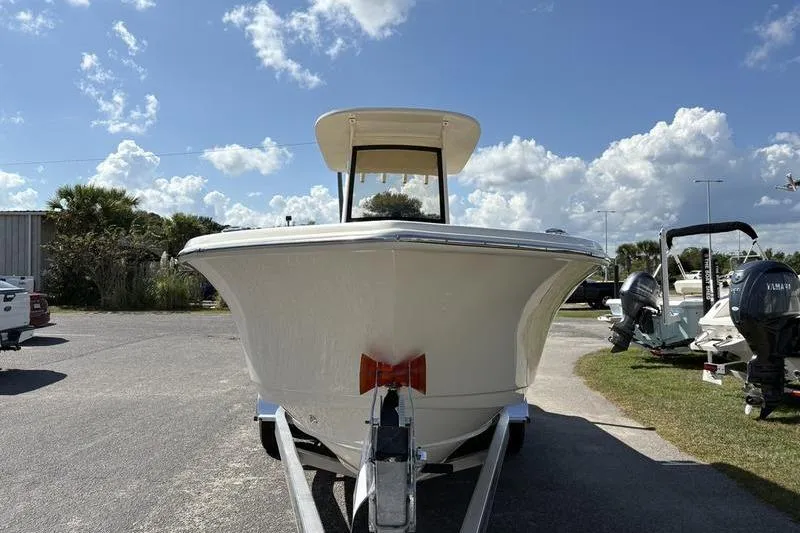 Slide: The Image of 2026 Scout 240 XSF boat on trailer under a clear blue sky. - 6