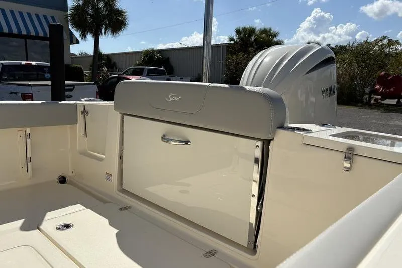 Slide: The Image of 2026 Scout 240 XSF boat interior with storage compartment and outboard motor. - 8