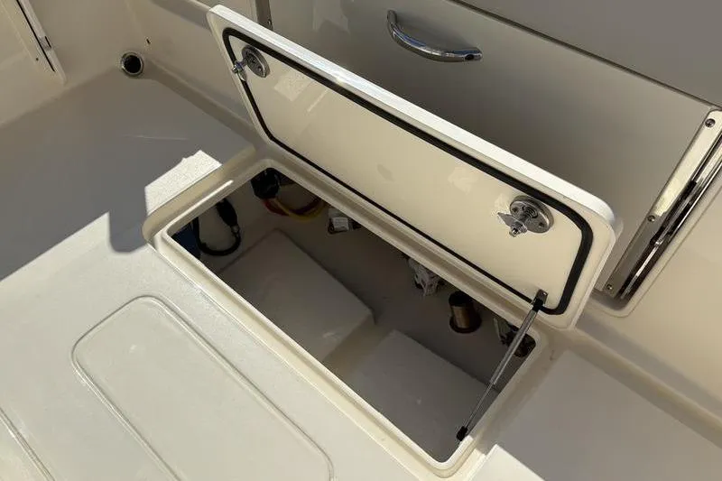 Slide: The Image of Open storage compartment on 2026 Scout 240 XSF boat, showcasing interior space and design. - 9