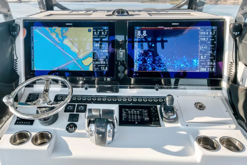 Slide: The Image of Freeman 42 LR 2022 boat dashboard with dual Simrad displays and navigation controls. - 15