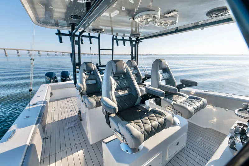 Slide: The Image of Luxurious 2022 Freeman 42 LR boat interior with plush seating on calm waters. - 16