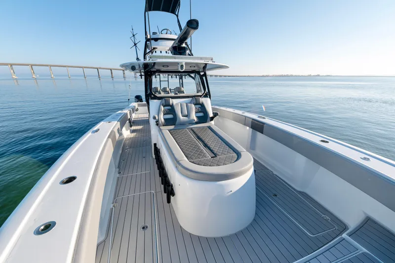 Slide: The Image of 2022 Freeman 42 LR boat on calm water, showcasing sleek design and spacious deck. - 17