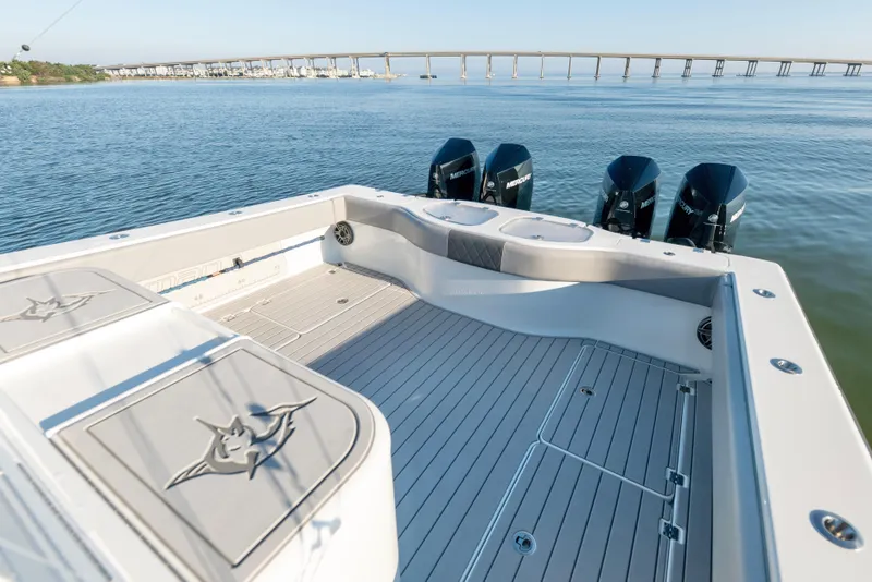 Slide: The Image of 2022 Freeman 42 LR boat with spacious deck and four outboard motors on calm water. - 19