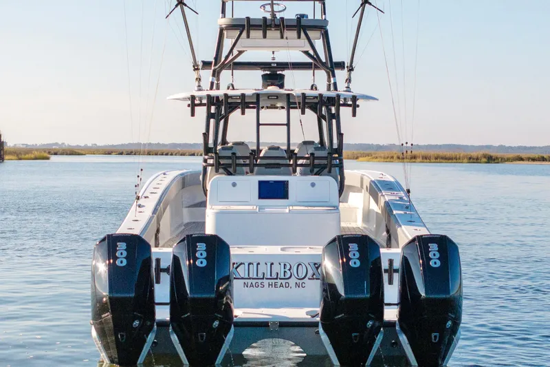 Slide: The Image of Freeman 42 LR 2022 boat with four engines on calm water. - 3