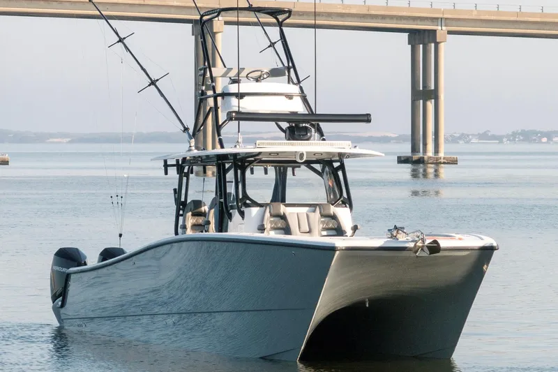 Slide: The Image of 2022 Freeman 42 LR boat on calm water near a bridge. - 4