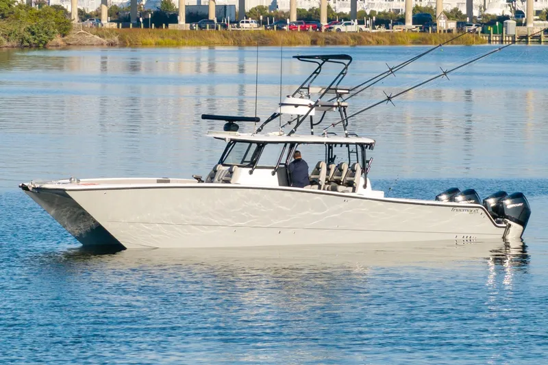 Slide: The Image of 2022 Freeman 42 LR boat on calm water, featuring multiple outboard motors. - 5