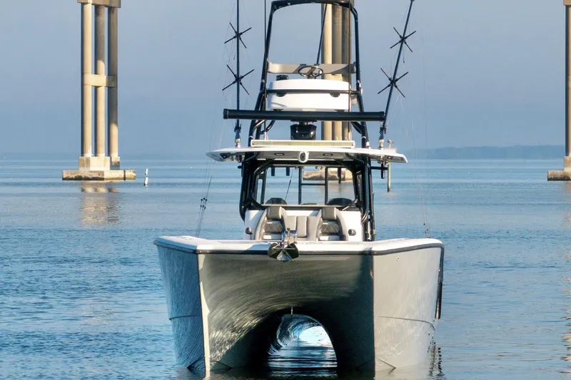 Slide: The Image of 2022 Freeman 42 LR boat on calm water near bridge pillars. - 7