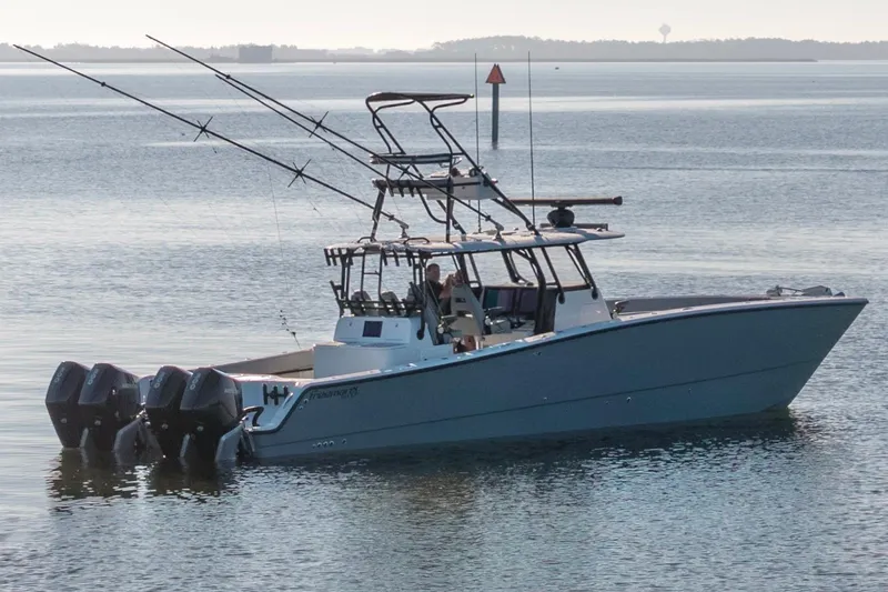 Slide: The Image of 2022 Freeman 42 LR fishing boat with multiple outboard motors on calm water. - 8