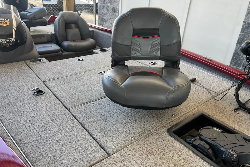 Slide: The Image of 2021 Bass Tracker Pro Team 195 TXW TE boat interior with gray seating and carpeted deck. - 11