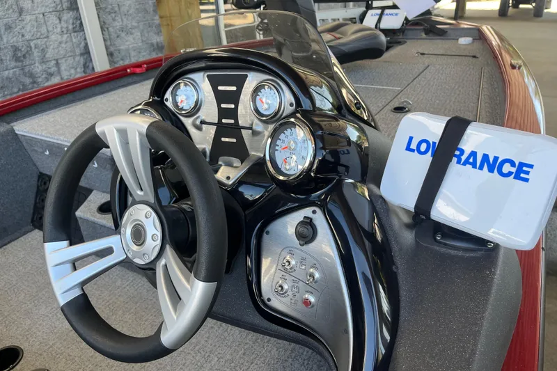 Slide: The Image of 2021 Bass Tracker Pro Team 195 TXW TE dashboard with steering wheel and Lowrance device. - 13