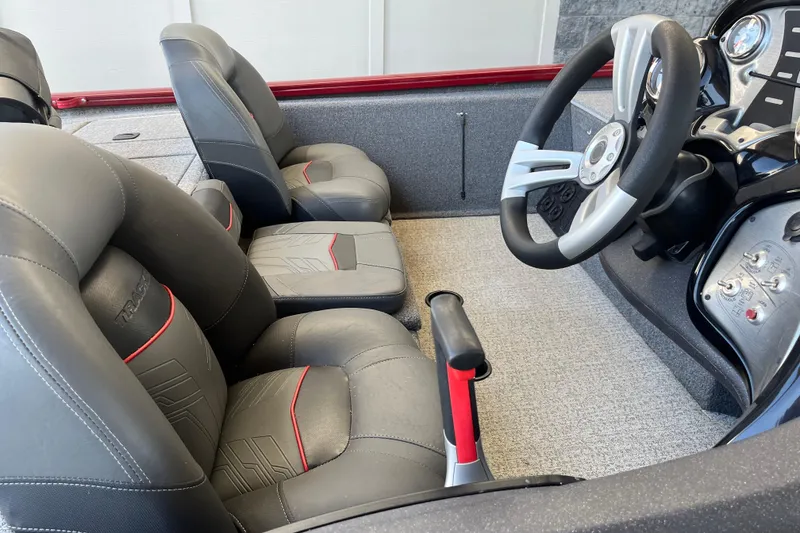 Slide: The Image of 2021 Bass Tracker Pro Team 195 TXW TE boat interior with steering wheel and seats. - 16