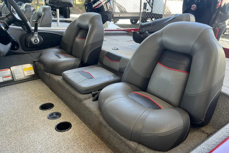 Slide: The Image of 2021 Bass Tracker Pro Team 195 TXW TE boat interior with plush seating and steering console. - 18