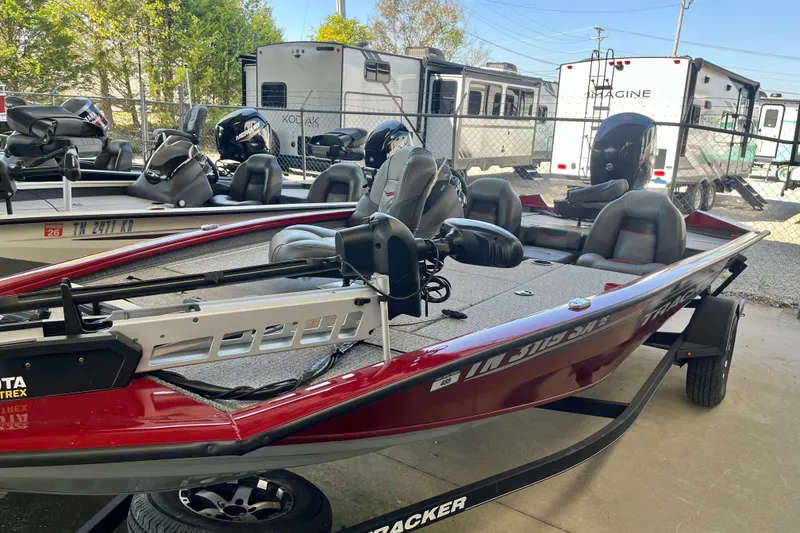 Slide: The Image of 2021 Bass Tracker Pro Team 195 TXW TE fishing boat in a storage lot. - 2