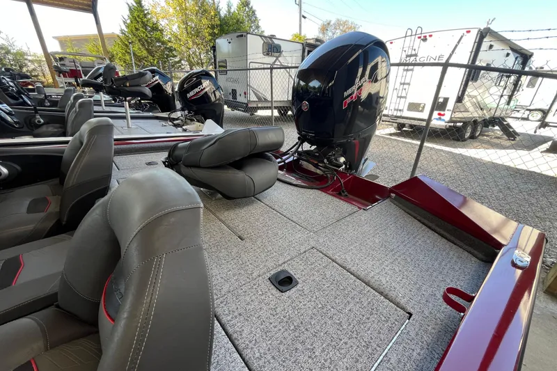 Slide: The Image of 2021 Bass Tracker Pro Team 195 TXW TE boat with Mercury engine, parked outdoors. - 21