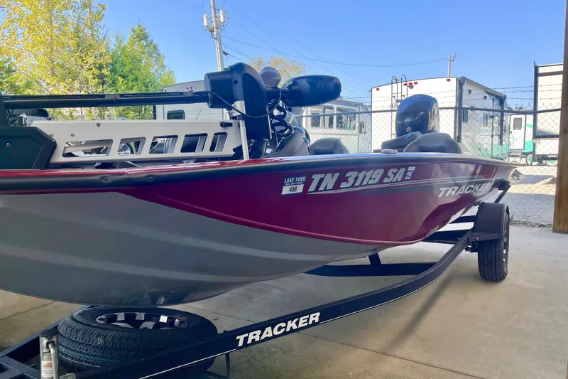 Slide: The Image of 2021 Bass Tracker Pro Team 195 TXW TE boat on trailer, parked outdoors. - 4