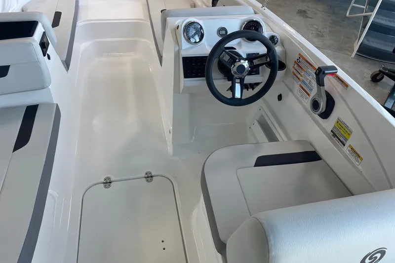 Slide: The Image of 2023 Hurricane SunDeck Sport 185 OB boat interior with steering wheel and seating. - 12