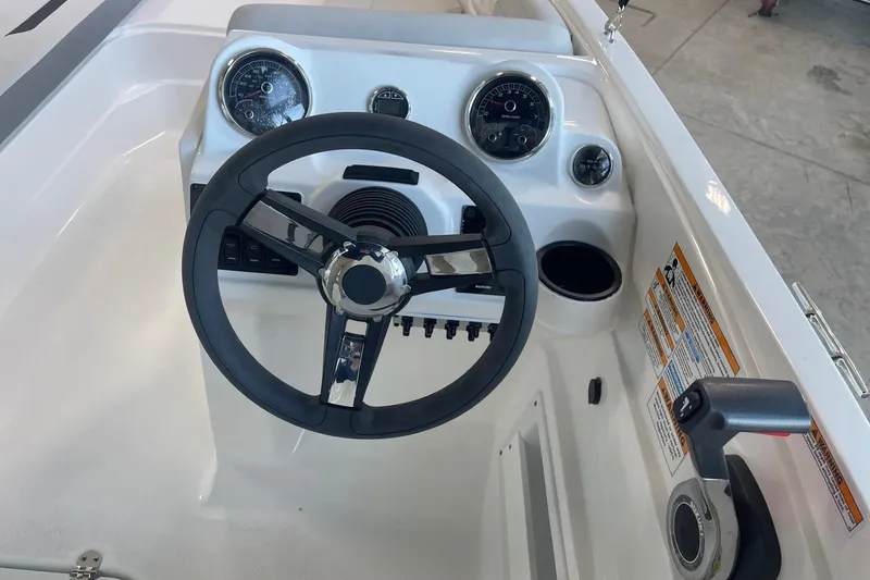 Slide: The Image of 2023 Hurricane SunDeck Sport 185 OB boat dashboard with steering wheel and gauges. - 14