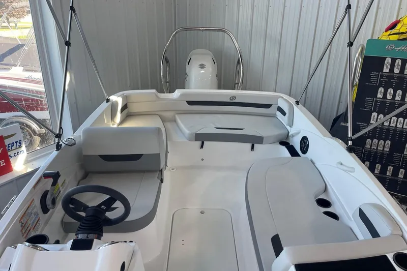 Slide: The Image of 2023 Hurricane SunDeck Sport 185 OB boat interior with seating and steering wheel. - 17