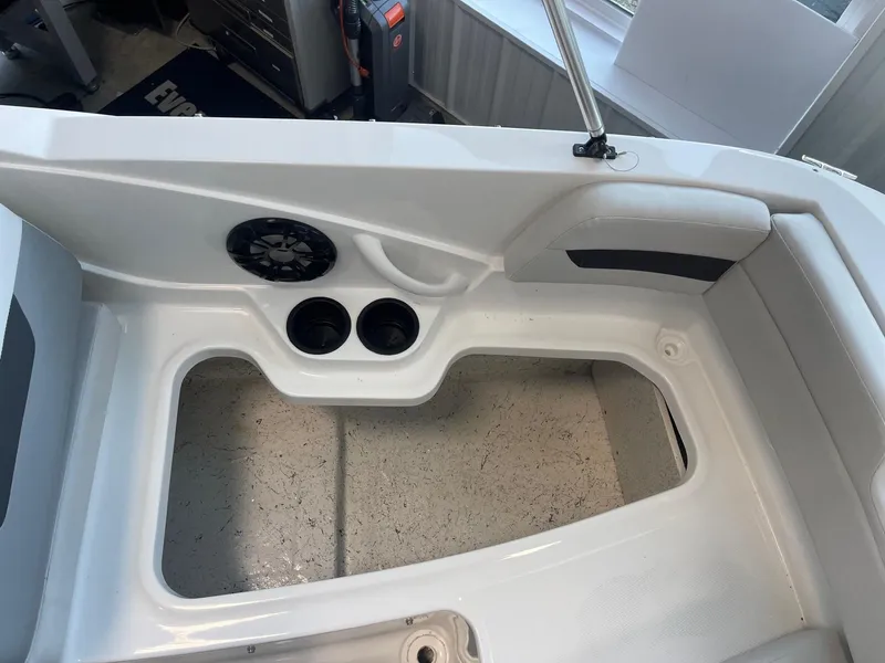 Slide: The Image of 2022 Hurricane SunDeck Sport 185 OB boat interior with cup holders and speaker. - 19