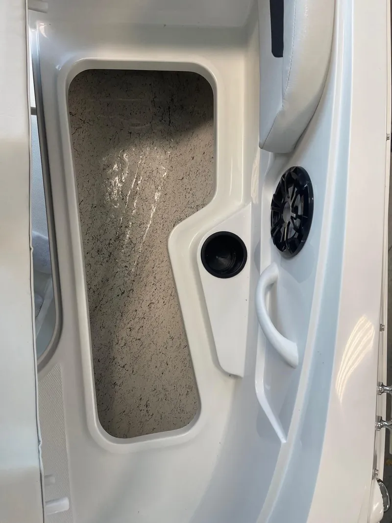 Slide: The Image of 2022 Hurricane SunDeck Sport 185 OB boat interior with storage compartment and speaker. - 20