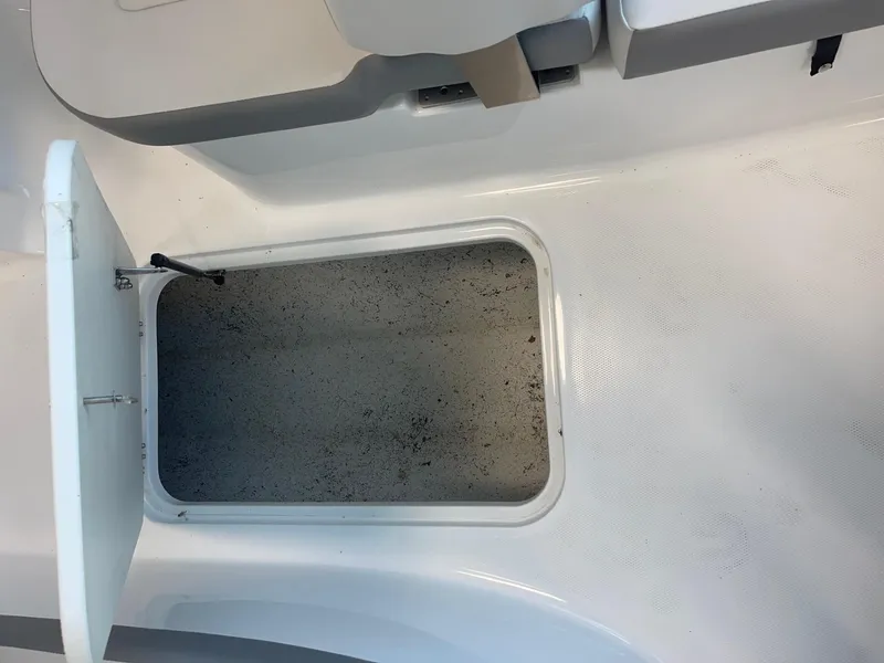 Slide: The Image of Open storage compartment on 2022 Hurricane SunDeck Sport 185 OB boat. - 21