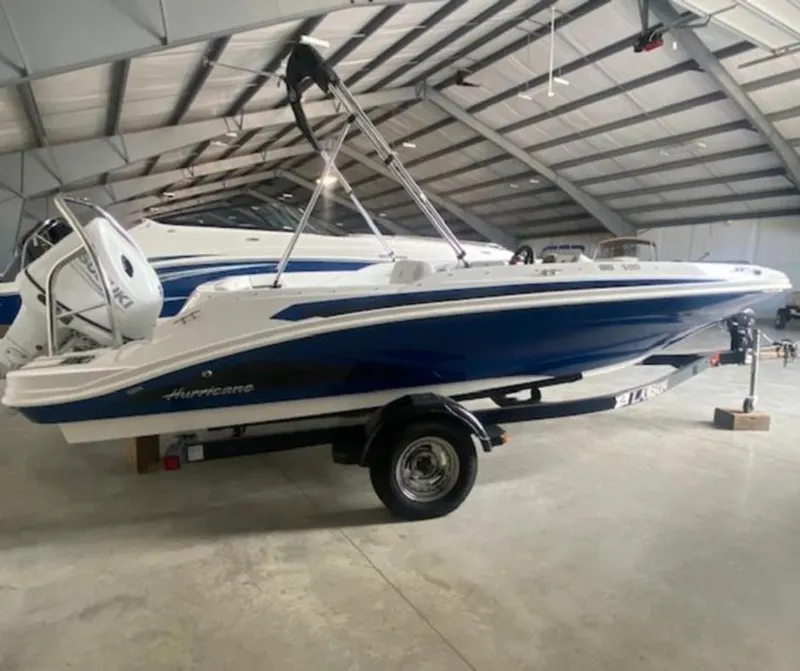 Slide: The Image of 2022 Hurricane SunDeck Sport 185 OB boat in a storage facility. - 23