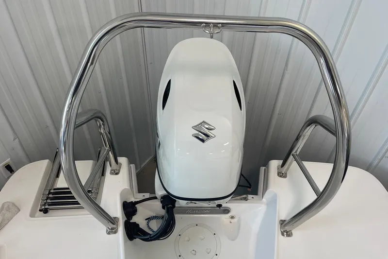 Slide: The Image of 2023 Hurricane SunDeck Sport 185 OB boat with Suzuki outboard motor and stainless steel railings. - 6