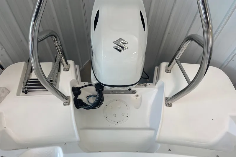 Slide: The Image of 2023 Hurricane SunDeck Sport 185 OB boat with Suzuki outboard motor and stainless steel rails. - 7