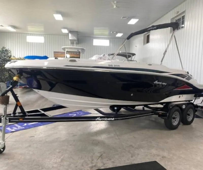 Slide: The Image of 2022 Hurricane SunDeck Sport 205 IO boat on trailer in indoor storage. - 0