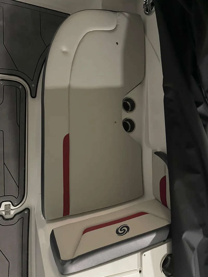 Slide: The Image of 2022 Hurricane SunDeck Sport 205 IO boat interior seating with red accents. - 16