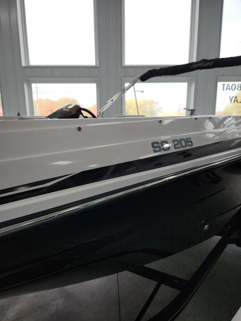 Slide: The Image of 2022 Hurricane SunDeck Sport 205 IO boat side view in showroom. - 4