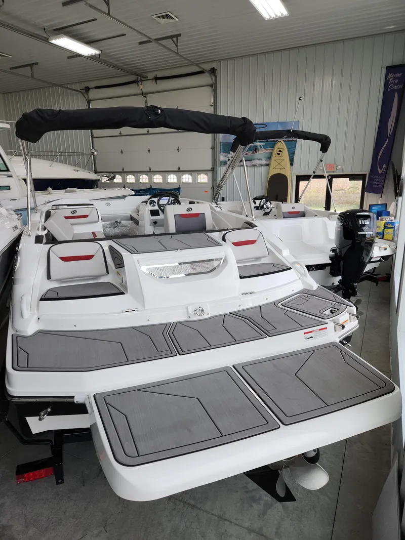 Slide: The Image of 2022 Hurricane SunDeck Sport 205 IO boat in indoor storage. - 6