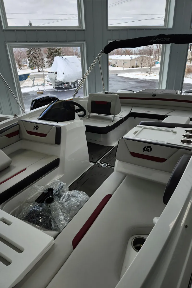 Slide: The Image of 2022 Hurricane SunDeck Sport 205 IO boat interior with seating and steering wheel. - 8