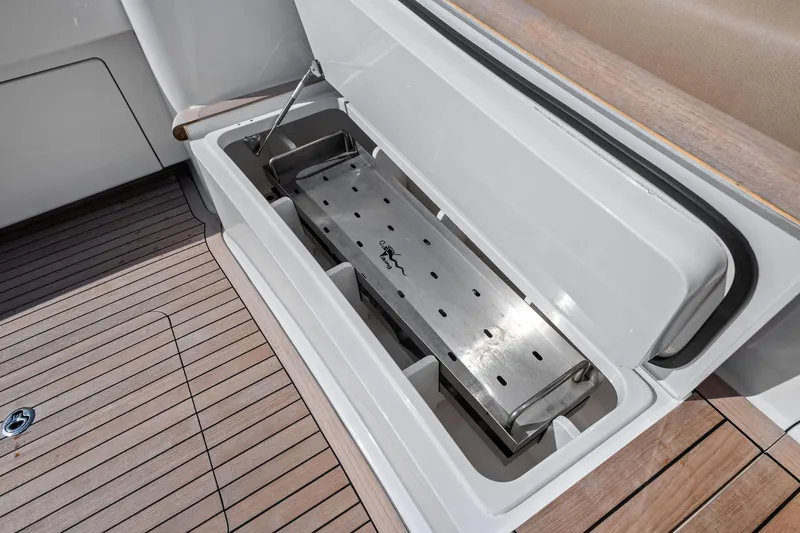 Slide: The Image of Open storage compartment on 2017 Viking 62 Enclosed Bridge yacht with wooden deck. - 16