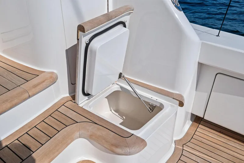 Slide: The Image of Open storage compartment on 2017 Viking 62 Enclosed Bridge yacht with teak flooring. - 17