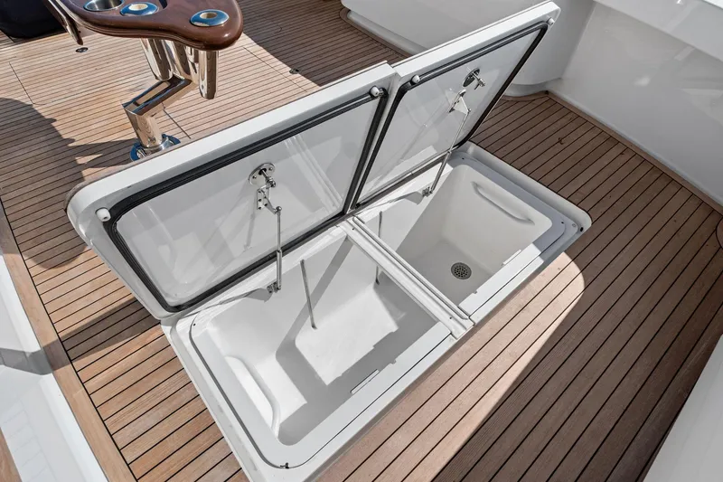 Slide: The Image of Open storage compartment on 2017 Viking 62 Enclosed Bridge yacht deck. - 23
