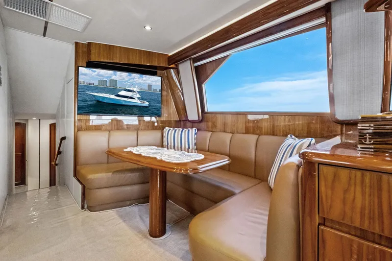 Slide: The Image of Luxurious interior of 2017 Viking 62 Enclosed Bridge yacht with dining area and ocean view. - 31